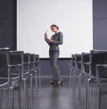 Woman practicing speech in empty presentation room